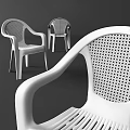 Red Plastic Leisure Chair with Perforated Back and Colorful Balls on Black Background