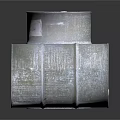 Silver Metal Drums Standing And Tilted With Label On Reflective Surface