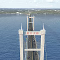 Humen Suspension Bridge With Tall Towers Over Blue Water And Moving Vehicles With Distant Landscape