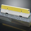 Yellow And White Concrete Road Barrier On Gravel Base Construction Component