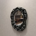 Black Irregular Shaped Bathroom Mirror With Textured Frame Hanging On Gray Wall Reflecting Interior 3d model