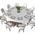 Modern Round Dining Table Set With White Tablecloth Green Plant And Eight White Chairs