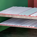 Plaster Moldings on Wooden Shelf with Various Shapes in Green and Red Wall Corner