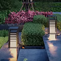 Outdoor Lights Illuminated Garden Pathway With Green Bushes And Landscaped Plants