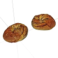 Two Golden Brown Swirled Bread Loaves With Almond Slices On White Background
