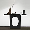 Modern Black Console Table With Circular Cutout Design And Decorative Items On Wooden Floor
