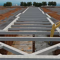 Construction Site Foundation Framework With Concrete Structure And Excavator Working