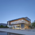 Modern Office Building With Glass Facade Main Entrance And Landscaped Surroundings