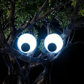 Artistic Tree Light Box Installation With Round Base And Green Foliage