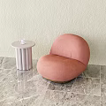 Pink Lounge Chair With White Round Side Table And Cup On Marble Floor