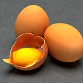 Fresh Chicken Eggs With One Cracked Shell And Exposed Yolk On Gray Surface 3d model