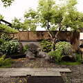 Traditional Japanese Garden Courtyard With Wooden Structure Stone Paths And Lush Greenery