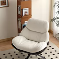 Plush White Lounge Chair With Wooden Shelf Wall Art And Green Plant