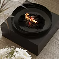 Modern Black Round Fireplace With Flames Wood Logs On Black Square Base Wooden Tabletop