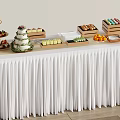 Inflatable Themed Buffet Table With White Tablecloth And Assorted Food Items