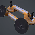 Two Yellow And Gray Industrial Tools With Round Base And Black Handles