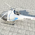 White Aerospatiale Helicopter With Transparent Cockpit Seats Blue Sky White Clouds Gray Stone Ground