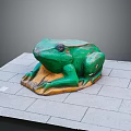 Green Reptile Sculpture On Gray Stone Paved Surface With Wooden Base