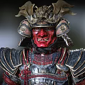 Red Faced Demon Character In Ornate Samurai Armor With Horned Helmet And Metallic Details