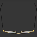 Round Eyeglasses With Gold Frame And Brown Temple Arms On Reflective Black Surface