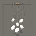 Modern Artistic Chandelier With White Stone Like Pendants On Black Hanging Wires For Interior Spaces