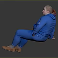 Woman in blue jumpsuit with white text sitting on black surface smiling in brown shoes