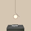 Elegant Spherical Pendant Light With Metal Frame Over Marble Countertop And Books