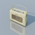 Cream Colored Vintage Grundig Radio With Handle On Light Blue Background And Reflection