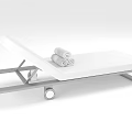 White Lounge Chair With Metal Frame Wheels And Rolled Towels On Top