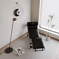 Modern Black Leather Lounge Chair in Minimalist Interior with Floor Fan Magazine and Potted Plant