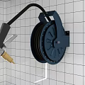 Commercial Kitchen Wall Mounted Hose Reel With Black Tube On White Tiled Wall