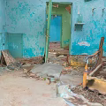 Abandoned Indoor Scene With Blue Walls Peeling Paint Debris And Broken Furniture
