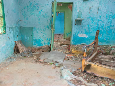 Abandoned Indoor Scene With Blue Walls Peeling Paint Debris And Broken Furniture 3d model