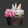 Colorful Unicorn Themed Cupcake With Multicolored Frosting And Decorative Toppings