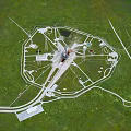 Futuristic Circular Complex Aerial View With Central Tower And Radial Roads On Green Grassland