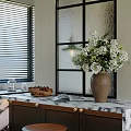 Kitchen With Marble Countertop Black Framed Glass Partition White Flower Bouquet And Brass Handle Cabinets