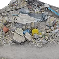 Pile of Construction Debris With Rubble Bricks Metal Sheets Yellow Blue Buckets And Dirt Path
