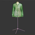 Stylish Long Sleeved Coat With Light Green And Beige Floral Pattern On Mannequin Stand