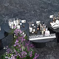 Luxury Tea Break Area With Round Black Tables Floral Decor And Manoir Royal Sign