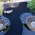 Commercial Landscape Design Featuring Trees White Chairs Circular Water Features And Black Modern Flooring