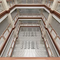 Multi Level Atrium Interior With Wooden Railings And Metal Flooring Design