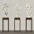 Three White Stone Sculptures On Dark Wooden Stands For Interior Display Decoration