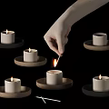 Human Hand Lighting Candle Among Multiple Lit Candles On Wooden Coasters With Matchstick