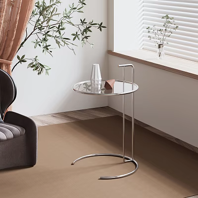 Modern Round Glass Top Side Table With Metal Frame Next To Armchair And Plant 3d model