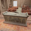 Ancient Chamber Interior With Stone Sarcophagus Wooden Statues And Carved Benches