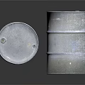 Silver Metal Drums Standing And Tilted With Label On Reflective Surface