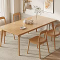 Cozy Indoor Wooden Dining Table Set With Four Chairs Tea Set Vase And White Flowers