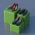 Stylish Shoes Displayed on Green Cubes Including Red High Heels and Black Pairs