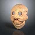 Ancient Clay Mask Featuring Prominent Eye Holes And Primitive Facial Design