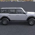 Silver Ford Bronco SUV With Large Off Road Tires And Modern Front Design